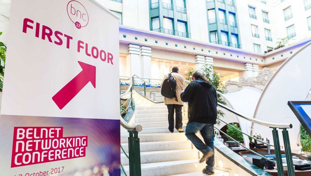 Two men walking up stairs to building