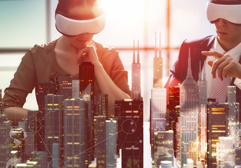 Two people blindfolded sitting in front of a model of a city skyline