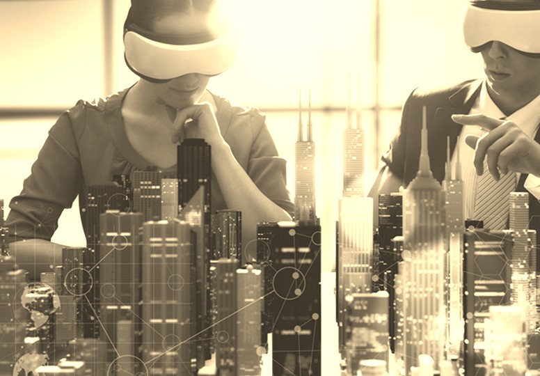 Two people blindfolded sitting in front of a model of a city skyline