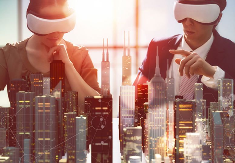 Two people blindfolded sitting in front of a model of a city skyline