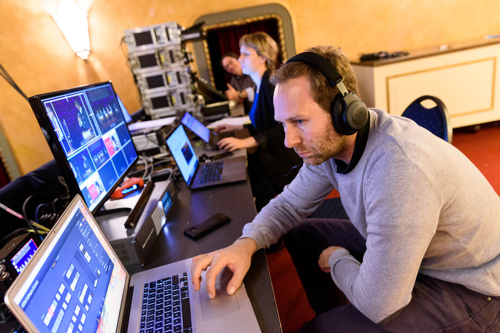People looking at computers in the technical area of the Roma Platform