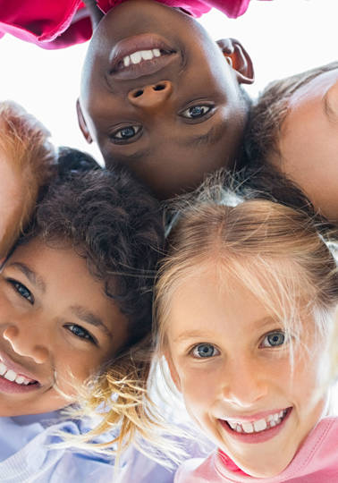 View of happy children smiling in front of a camera